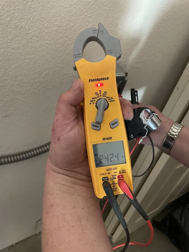 Voltage testing with clamp meter during Electrical Installation Services in North Manchester